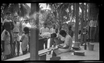 cho malakai veisamasama and ni vanuatu man look through microscope