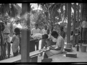 cho malakai veisamasama and ni vanuatu man look through microscope